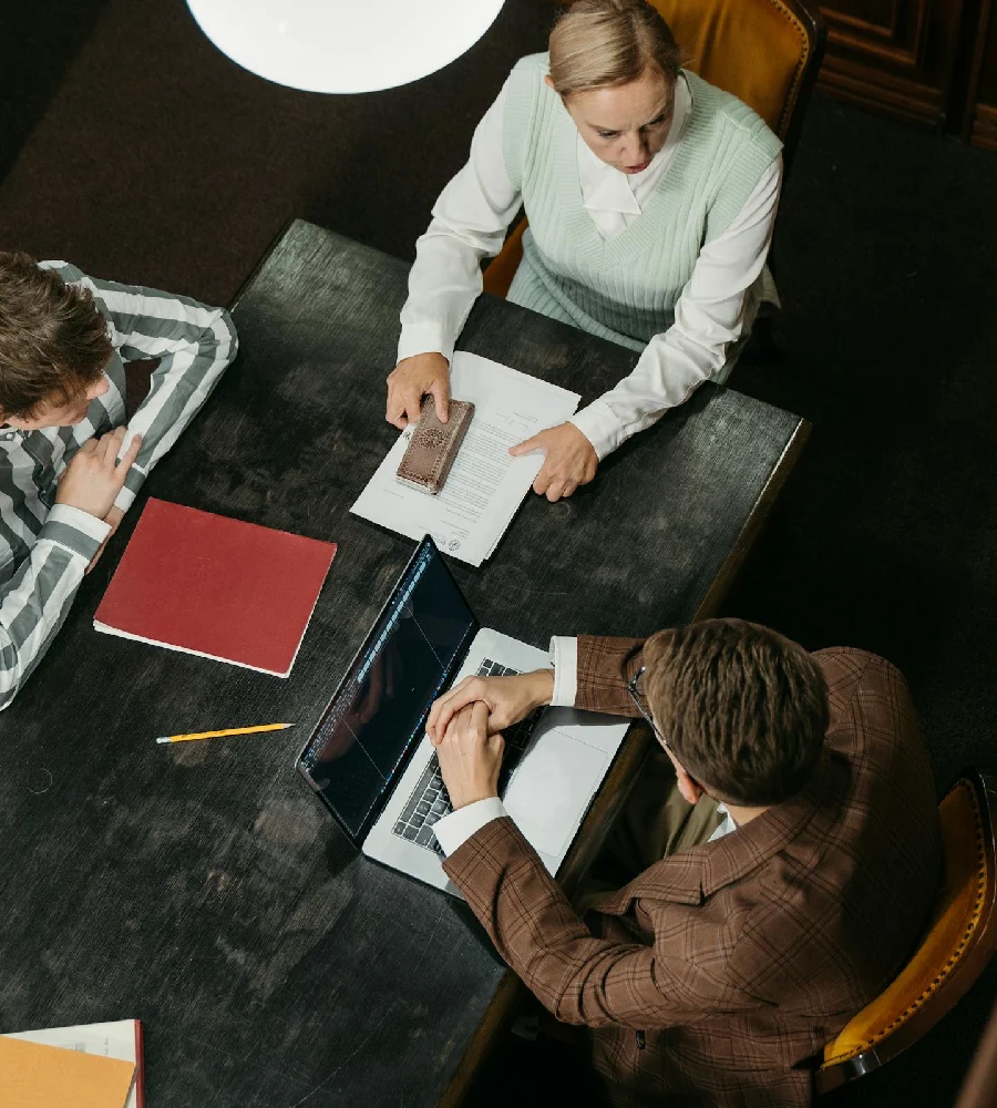 Business advisory meeting with executives reviewing documents and strategy